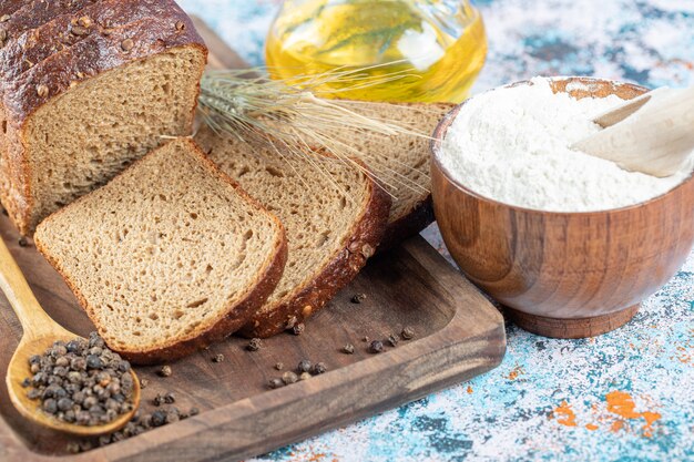 A wooden cutting board with slices of bread.