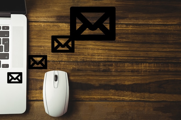 Wooden desk with a mouse and envelopes