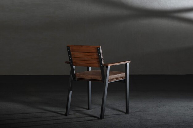 Wooden dining room chair in a studio with gray walls