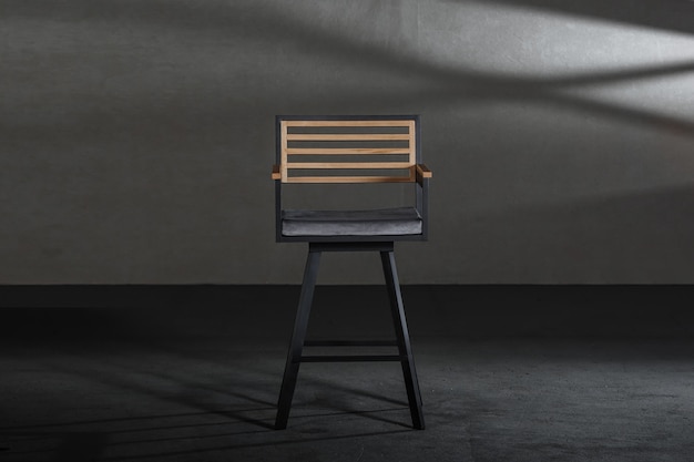 Wooden dining room chair in a studio with gray walls