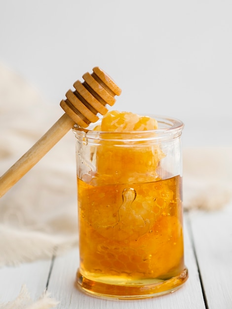 Wooden dipper on honey jar