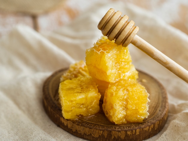 Wooden dipper on honeycombs