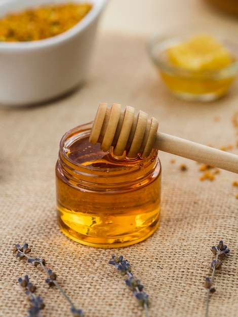 Wooden dipper in natural honey