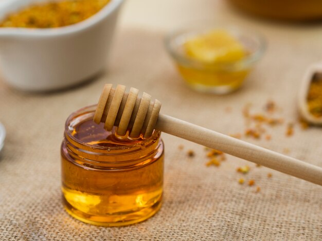 Wooden dipper in sticky honey