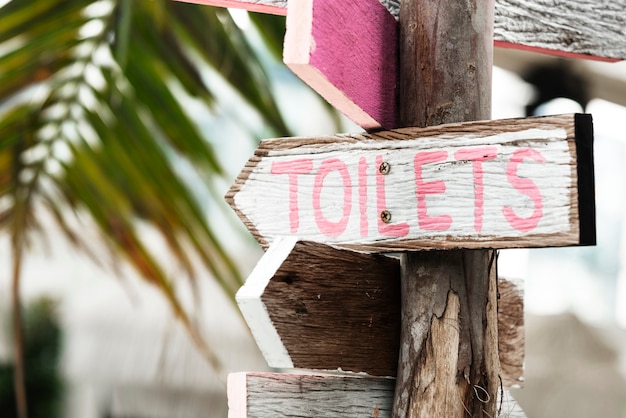 Wooden direction signage to the toilets