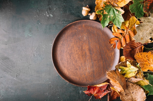 Wooden dish in fall leaves