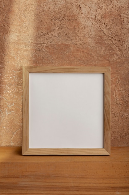 Wooden empty frame with stucco background
