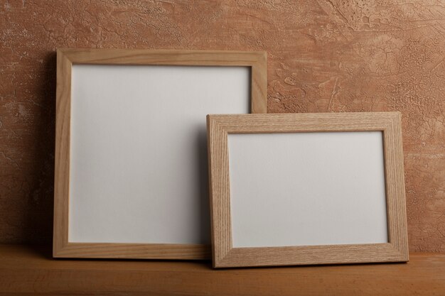 Wooden empty frames with stucco background
