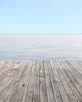 Free photo wooden floor and blue sea with waves and clear blue sky