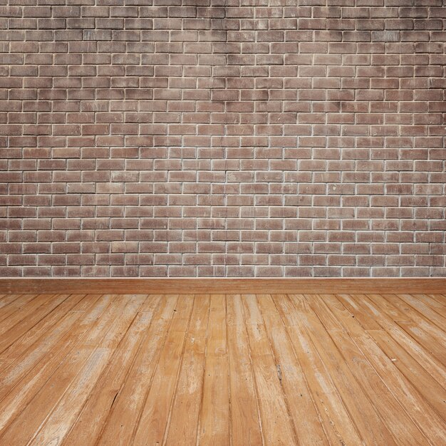 Wooden floor with brick wall