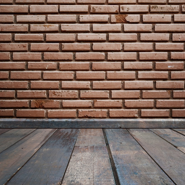 Wooden floor with brick wall