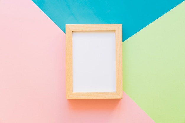 Wooden frame on colorful background