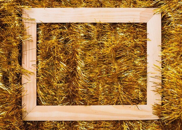 Wooden frame on gold tinsel 