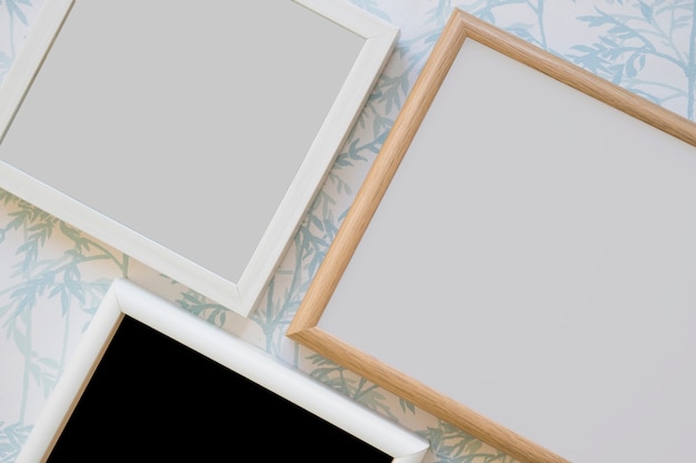 Free photo wooden frame on wallpaper