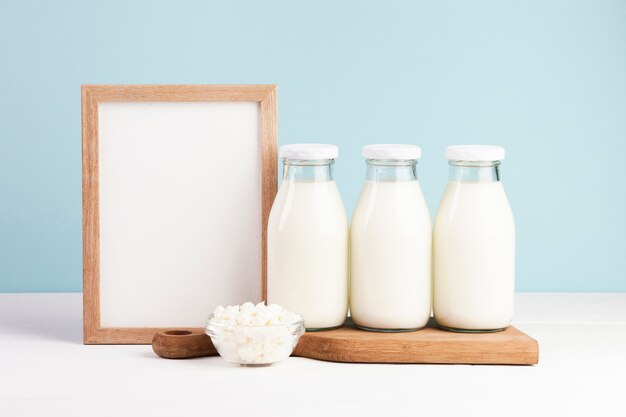 Wooden frame with bottles of milk