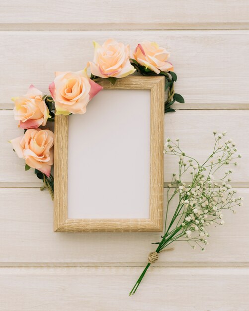 Wooden frame with floral ornament and bouquet of flowers