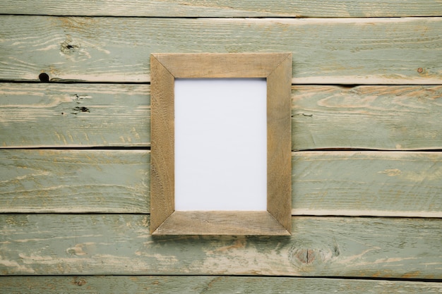 Free photo wooden frame with light wooden background