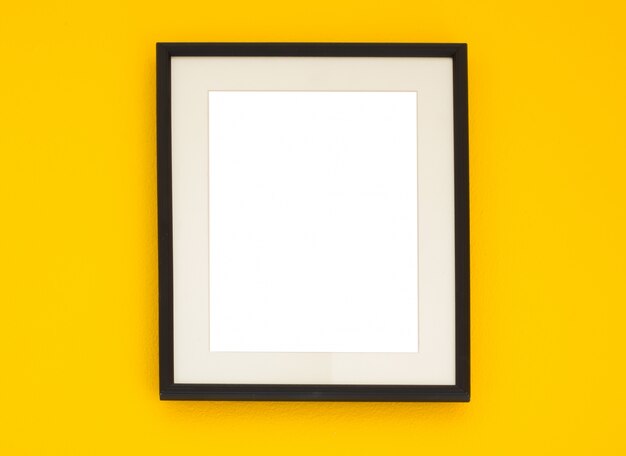 Wooden frame on the yellow wall