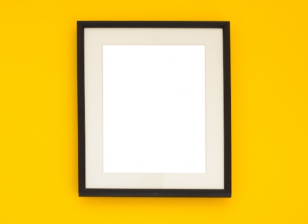 Wooden frame on the yellow wall