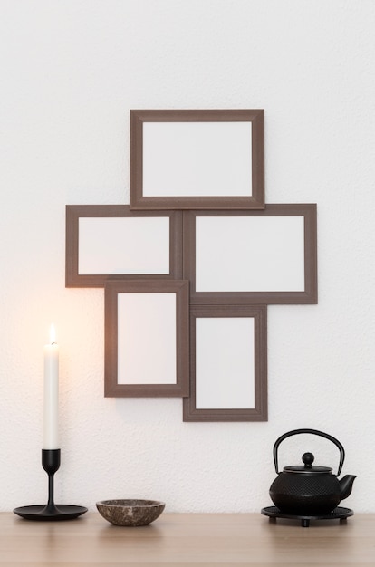 Wooden frames on wall and candle