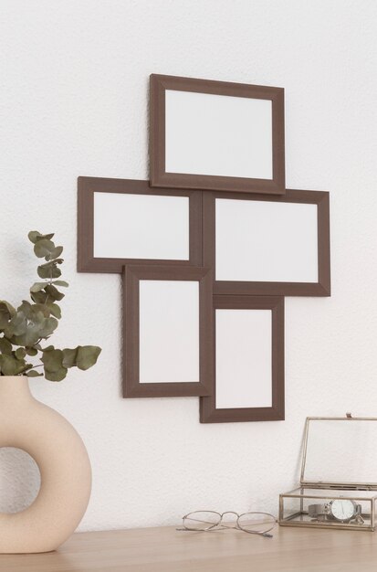 Wooden frames on wall and ornamental plant