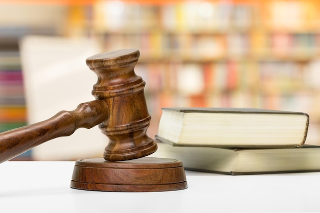 Wooden gavel and books on wooden table