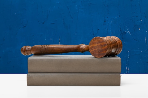 Wooden gavel and books on wooden table