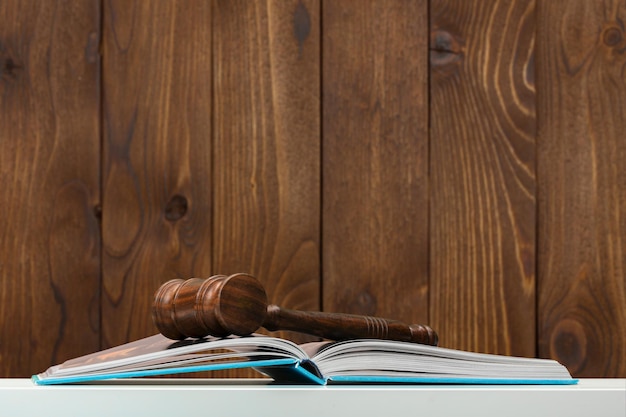 Wooden gavel and books on wooden table