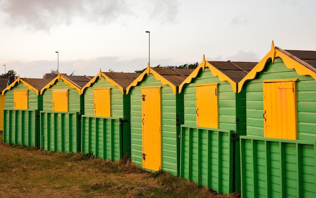 Free photo wooden green and yellow cottages in the rural area