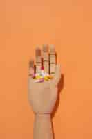 Free photo wooden hand with pills