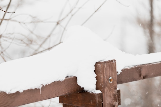 Wooden handrail in winter forest