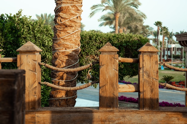 Wooden handrails with intertwined rope close up.