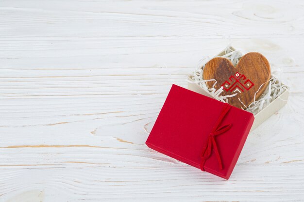 Wooden heart in opened present box