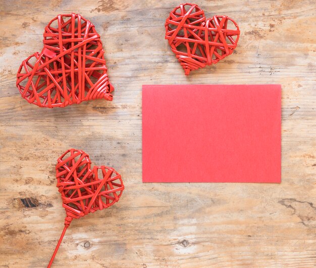 Wooden hearts with blank paper 