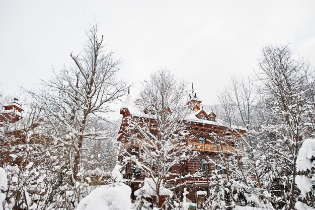 Wooden house at pine trees forest covered by snow Beautiful winter landscapes Frost nature