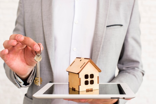 Wooden house on a tablet close view