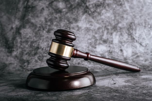 Wooden judges gavel on table in a courtroom or enforcement office.