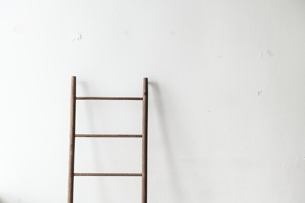 Wooden ladder leaning against a wall