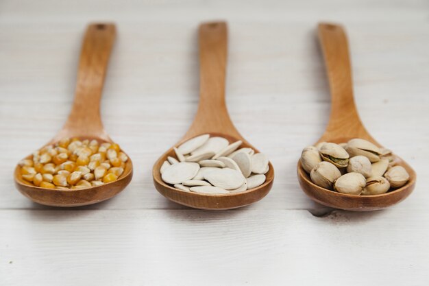 Wooden ladles full of seeds and nuts