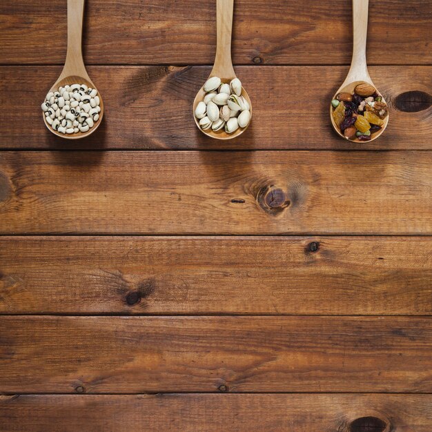 Wooden ladles with beans and nuts