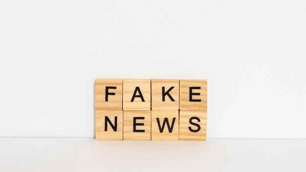 Free photo wooden letters with fake news