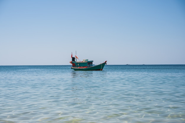 Wooden motor boat with a Vietnamese flag