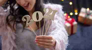 Free photo wooden new years number in the hands of a girl close up.