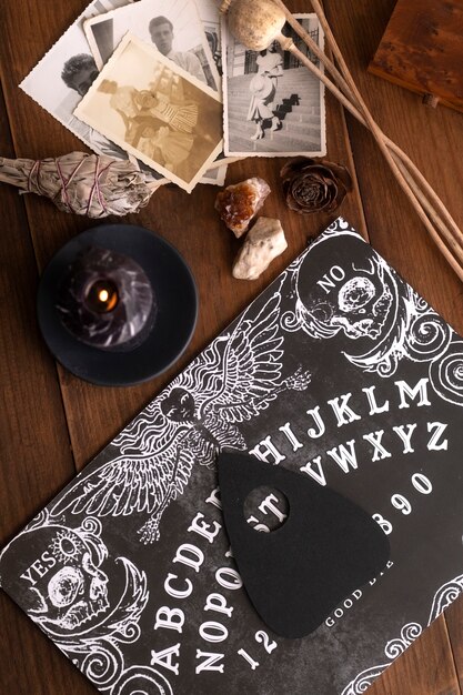 wooden ouija board and old photos top view