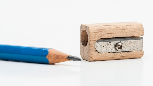 Free photo wooden pencil sharpener with blue pencil