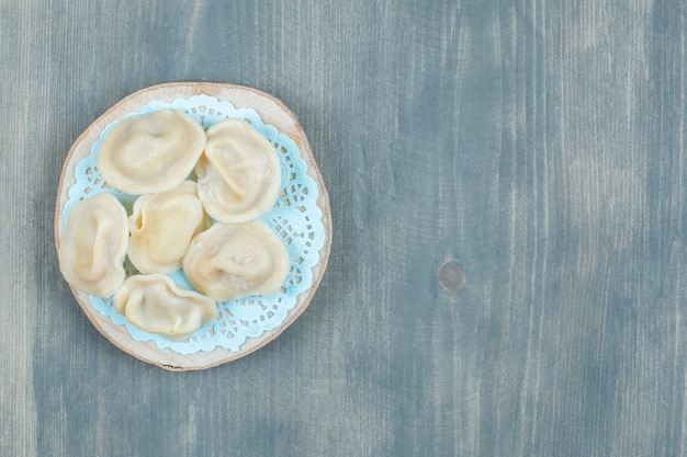 Free photo wooden piece of boiled meat dumplings on wooden surface.