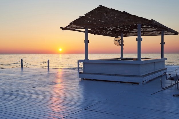 Wooden pier on a fancy orange sunset.