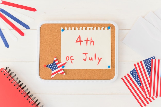 Free photo wooden plank with paper with text 4th of july