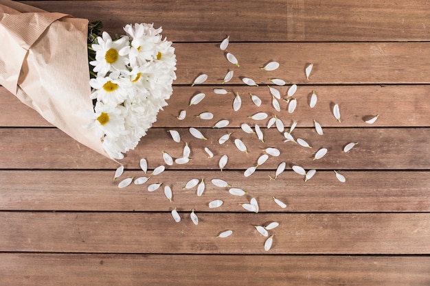 Wooden planks with a bouquet of daisies