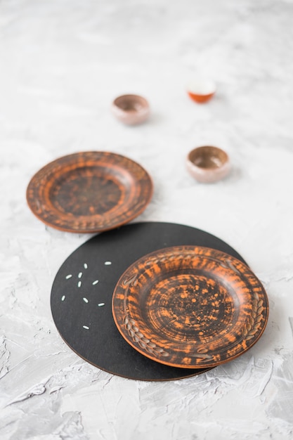 Wooden plate on concrete textured background